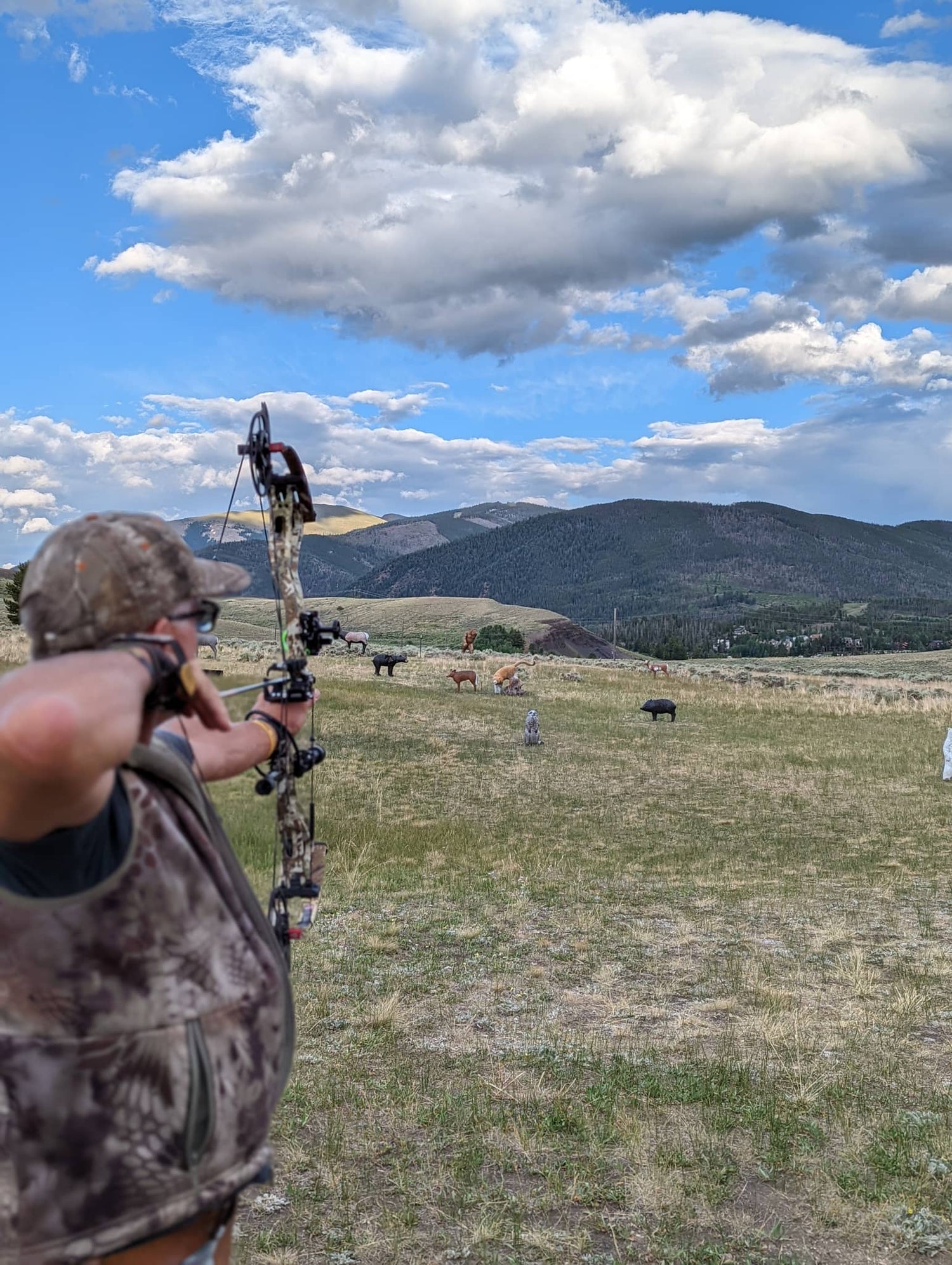 Archer aiming with camo compound bow and archery stabilizers for sale